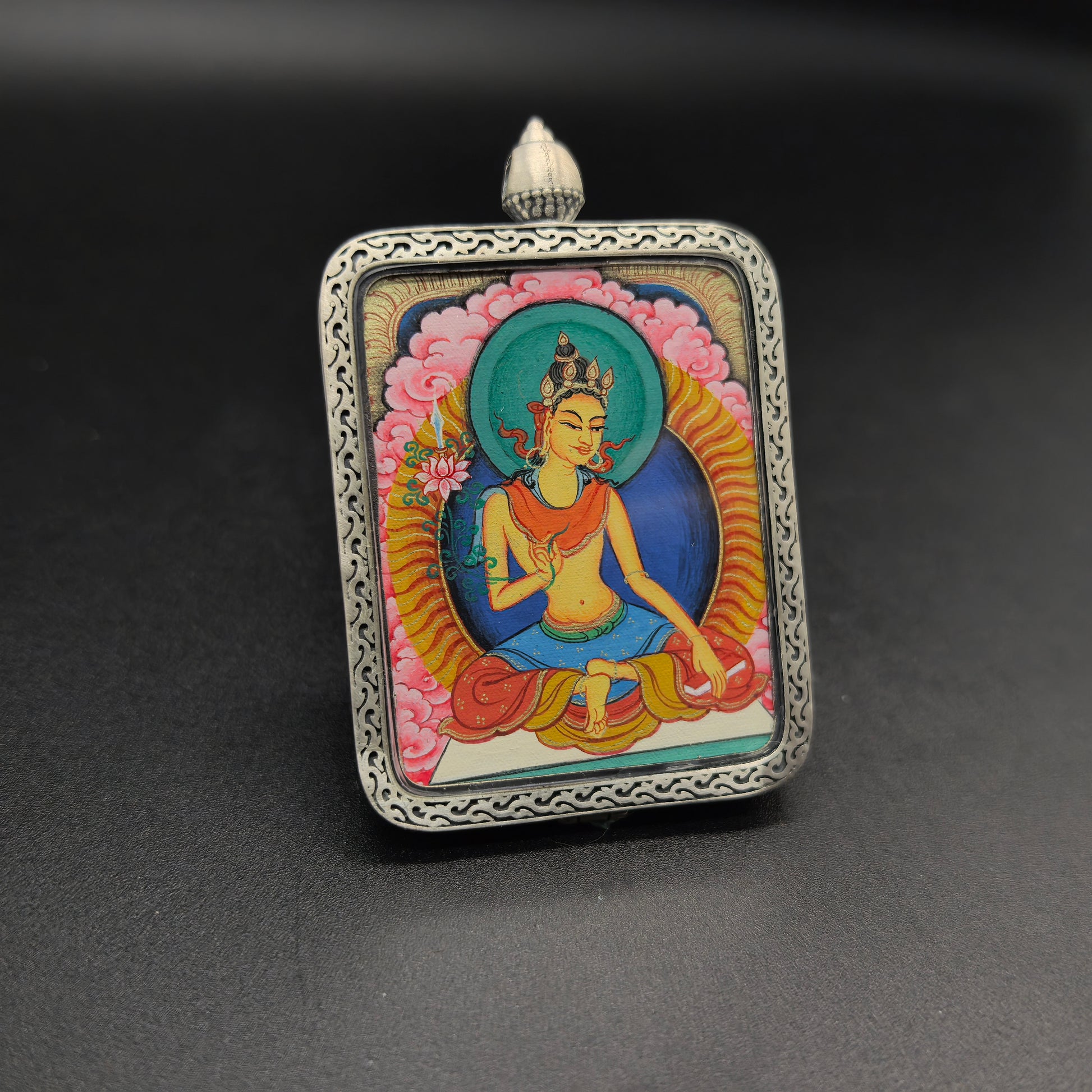 A 3.5x4.5cm hand-painted Tibet Red Cloud Manjushri (文殊菩萨) Thangka pendant with 925 silver featuring the Mother of all Buddhas and the wisdom deity, representing wisdom and blessing in Buddhist tradition.
