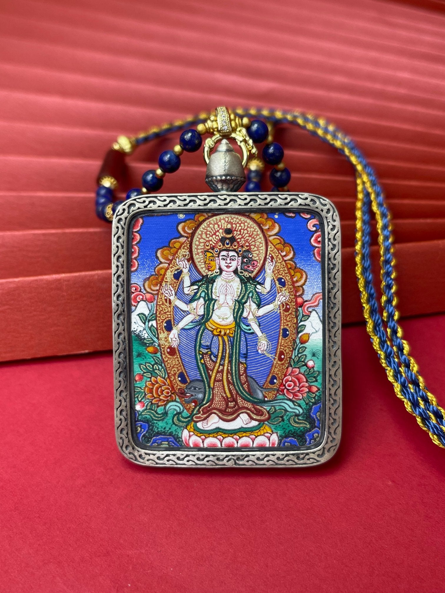 Hand-painted Rekong Marici (摩利支天) Thangka pendant 4x5cm with Dunhuang Nine-Colour Deer silver casing featuring the deity of great power and freedom, representing dispelling disaster in Buddhist tradition.
