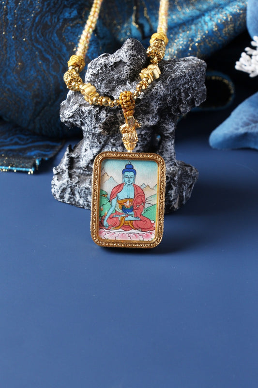  A 3.5x4.5cm hand-painted Tibetan Buddhist Medicine Buddha (Bhaisajyaguru) Thangka pendant featuring the Buddha of Healing, encased in exclusive 925 Sterling Silver, representing healing and longevity in Tibetan Buddhist culture.
