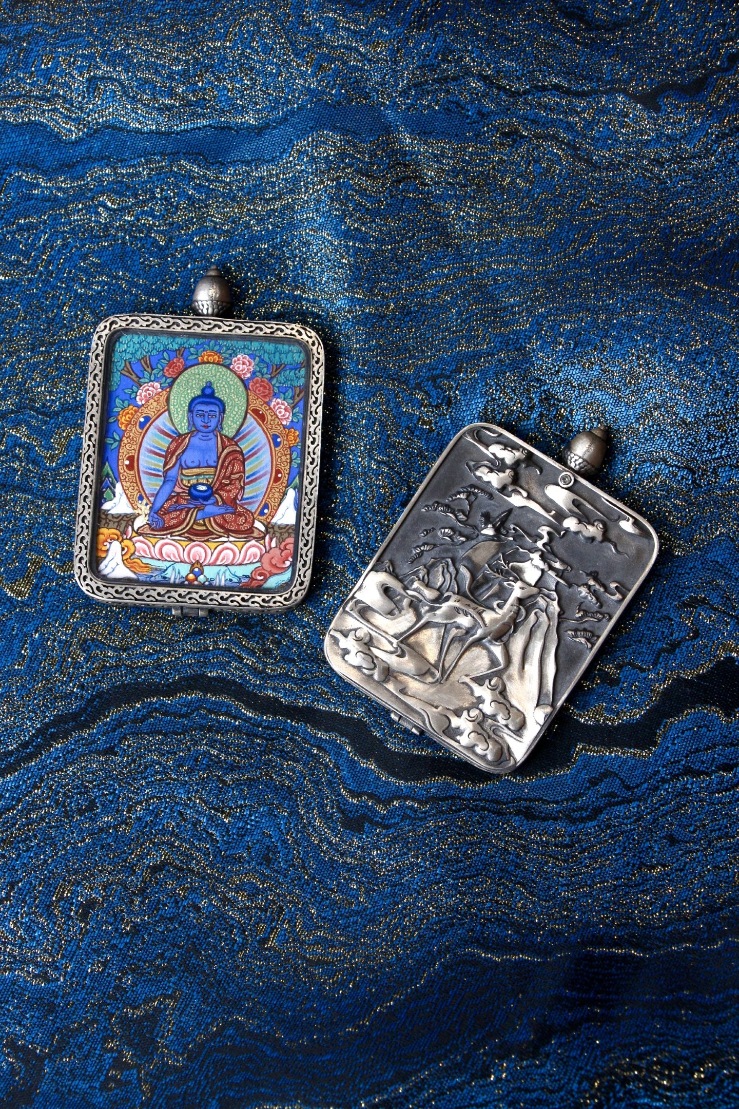 Close-up of the S925 sterling silver case with Dunhuang Nine-Colored Deer engraving, protecting the Medicine Buddha Thangka.