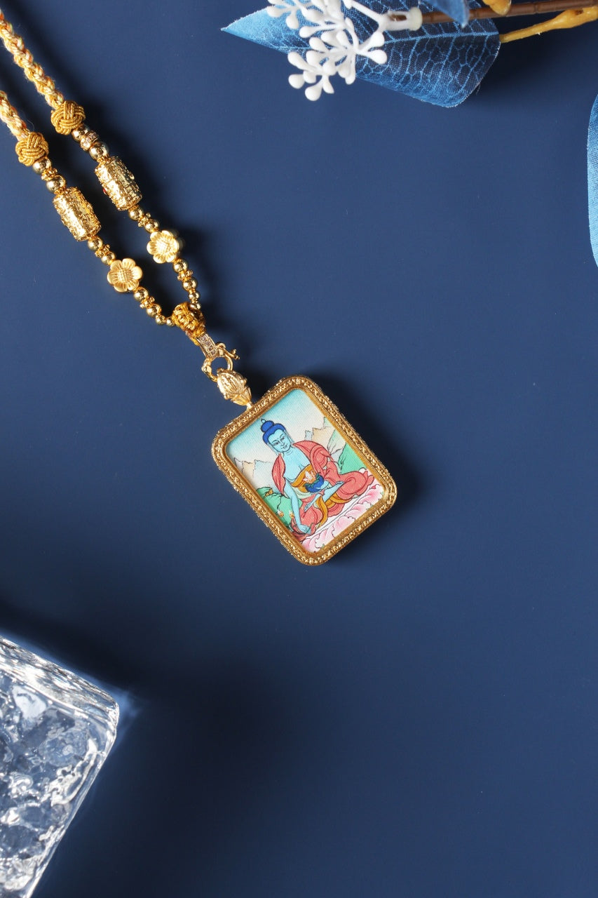 Detailed view of the exclusive 925 Sterling Silver casing for the Medicine Buddha Thangka pendant, symbolizing protection and elegance in Tibetan Buddhist tradition.

