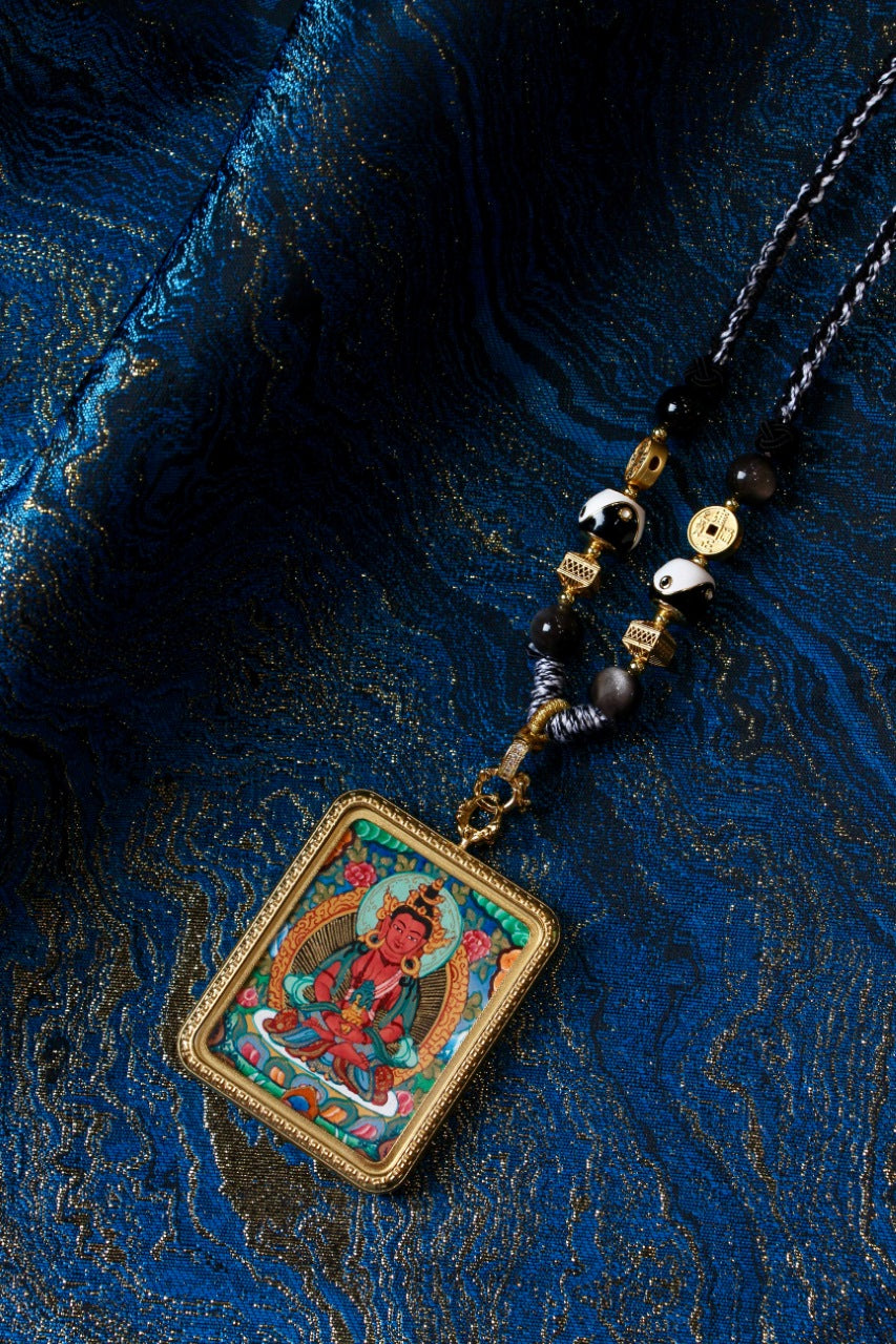 Tibetan thangka jewelry featuring the Medicine Buddha, inspired by traditional Tibetan Buddhist sacred art.