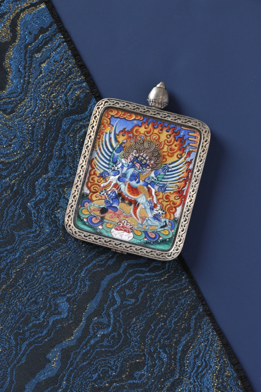 Tibetan thangka amulet featuring Phurba, revered in Tibetan Buddhism as a protector deity who subdues negative forces.