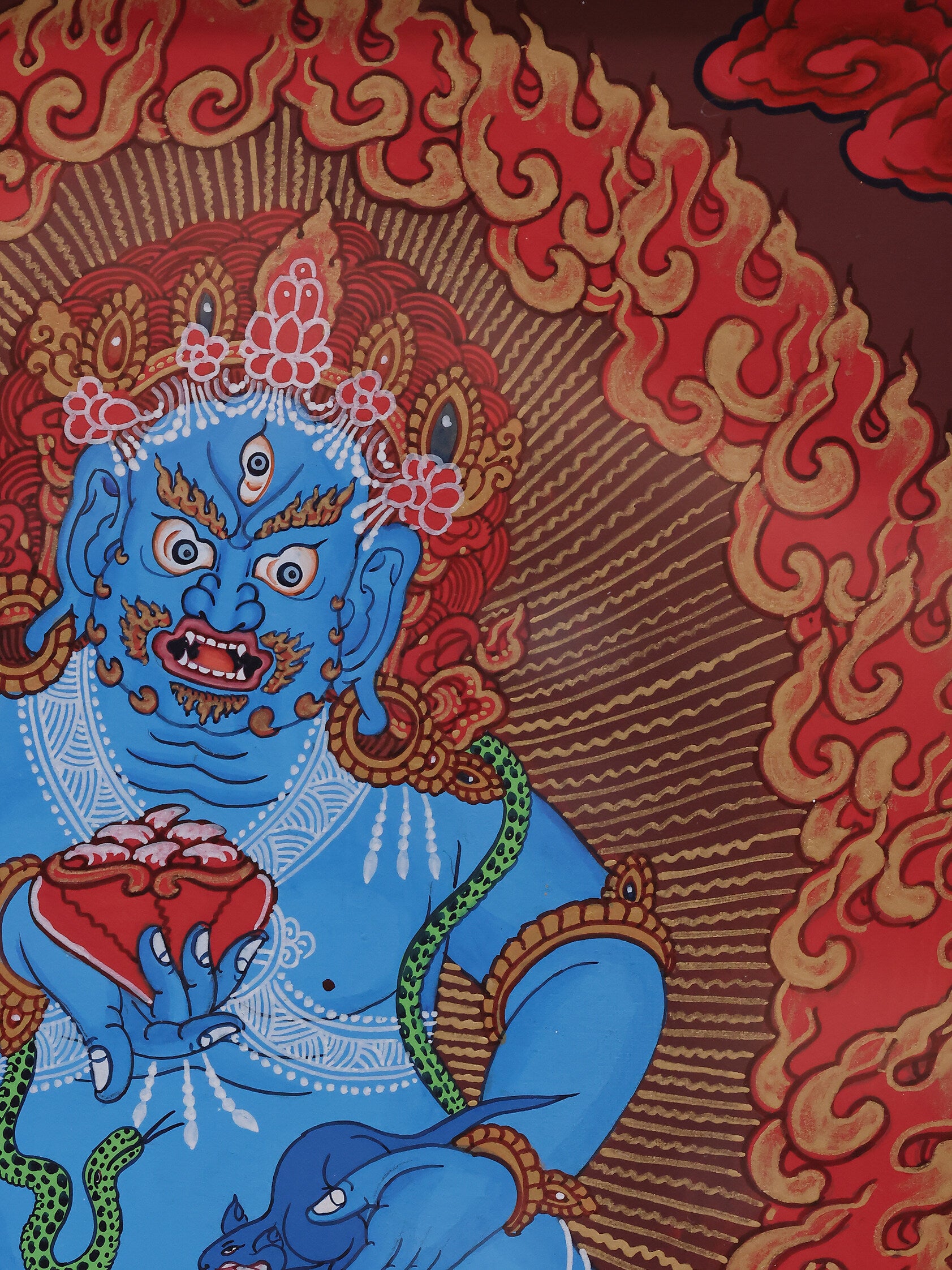 Himalayan red thangka artwork of Black Jambhala, the Buddhist god of wealth, painted in traditional Tibetan style