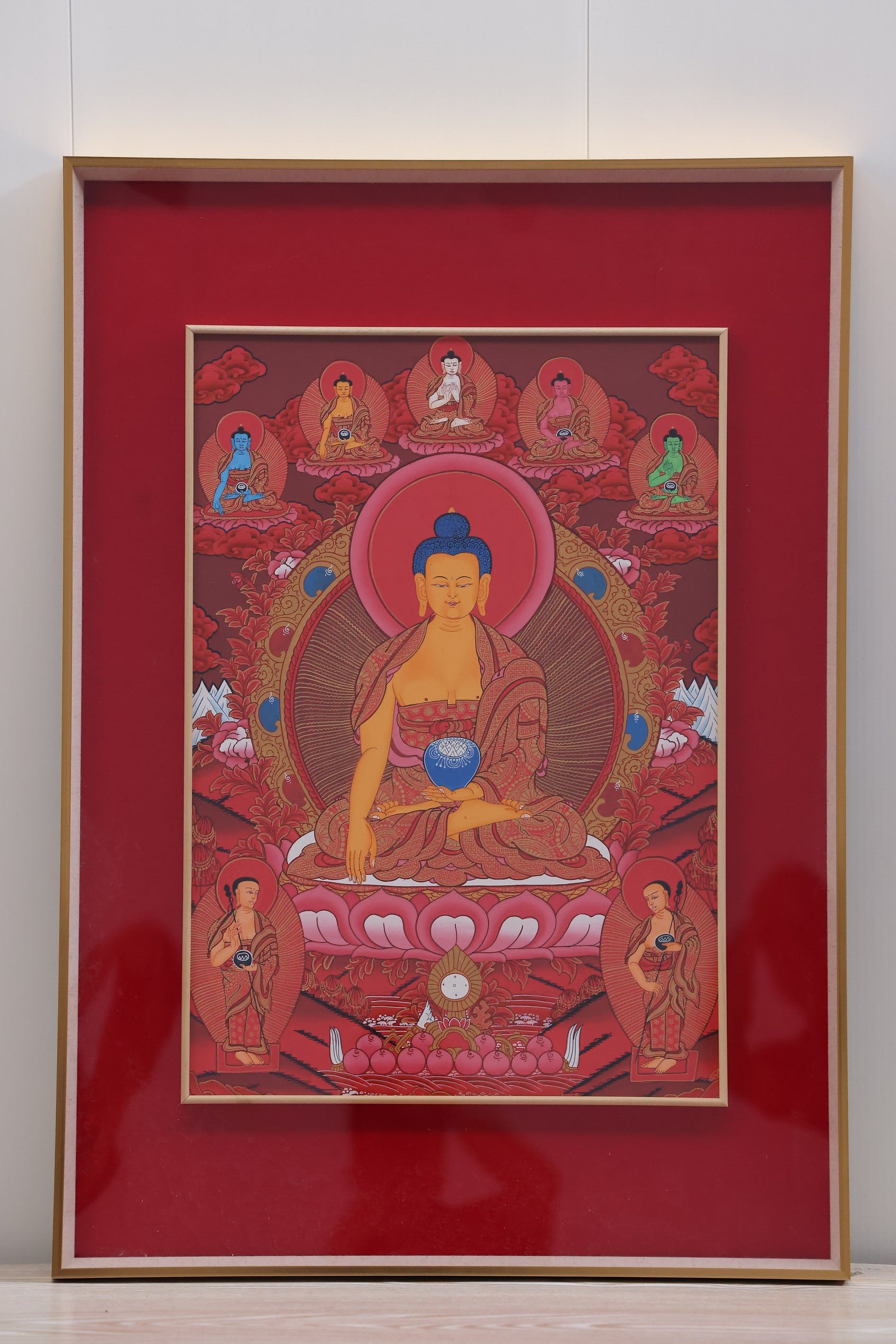 Red Shakyamuni Buddha depicted in a meditation posture, symbolizing serenity and enlightenment.