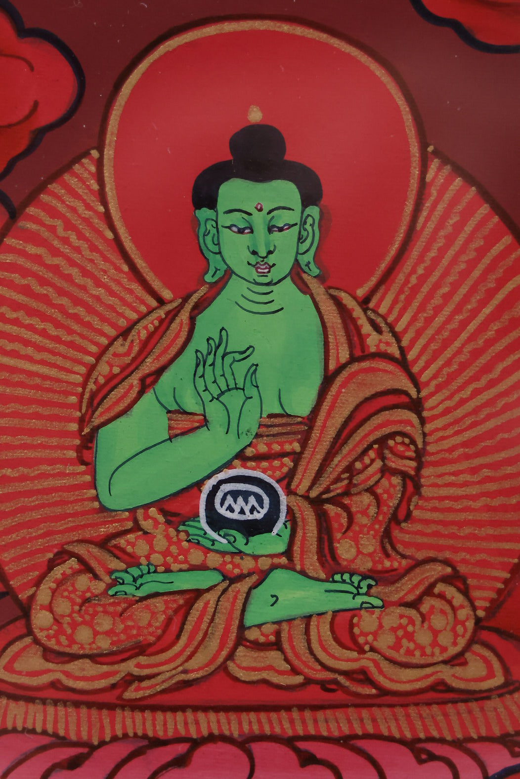 Red Shakyamuni Buddha with ritual symbolism, including ceremonial implements and sacred objects.