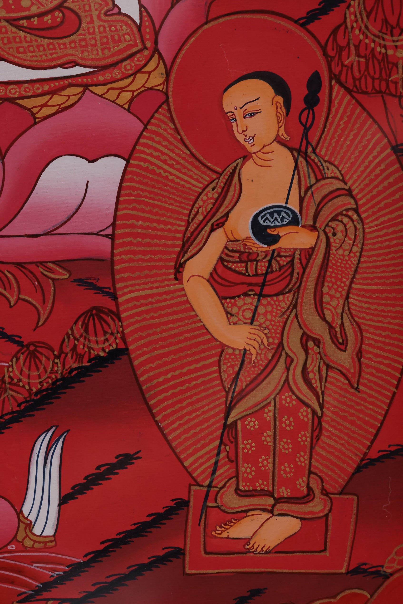 Red Shakyamuni Buddha painted with natural mineral pigments, highlighting traditional Tibetan craftsmanship.