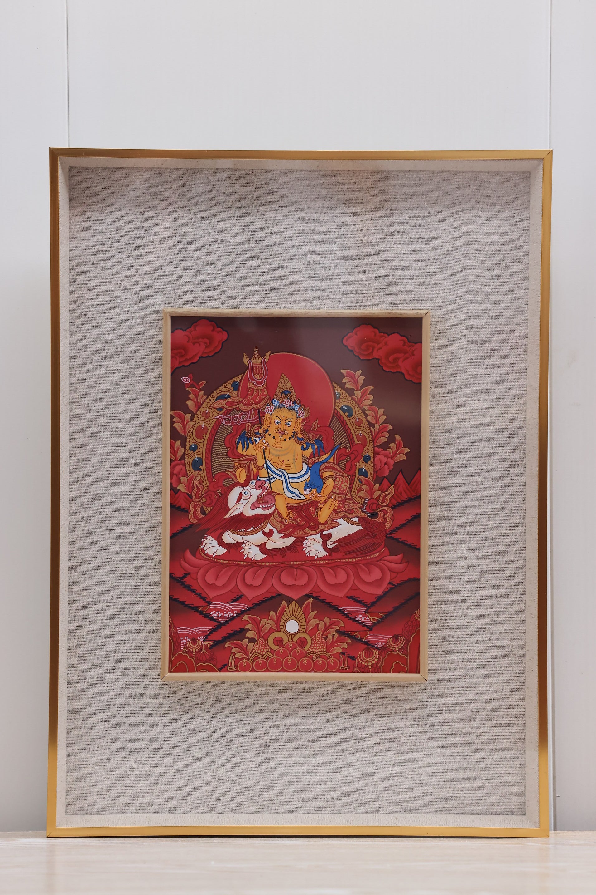 Alt: Red Thangka of a Tibetan deity, symbolizing wealth, fortune, and protection.
