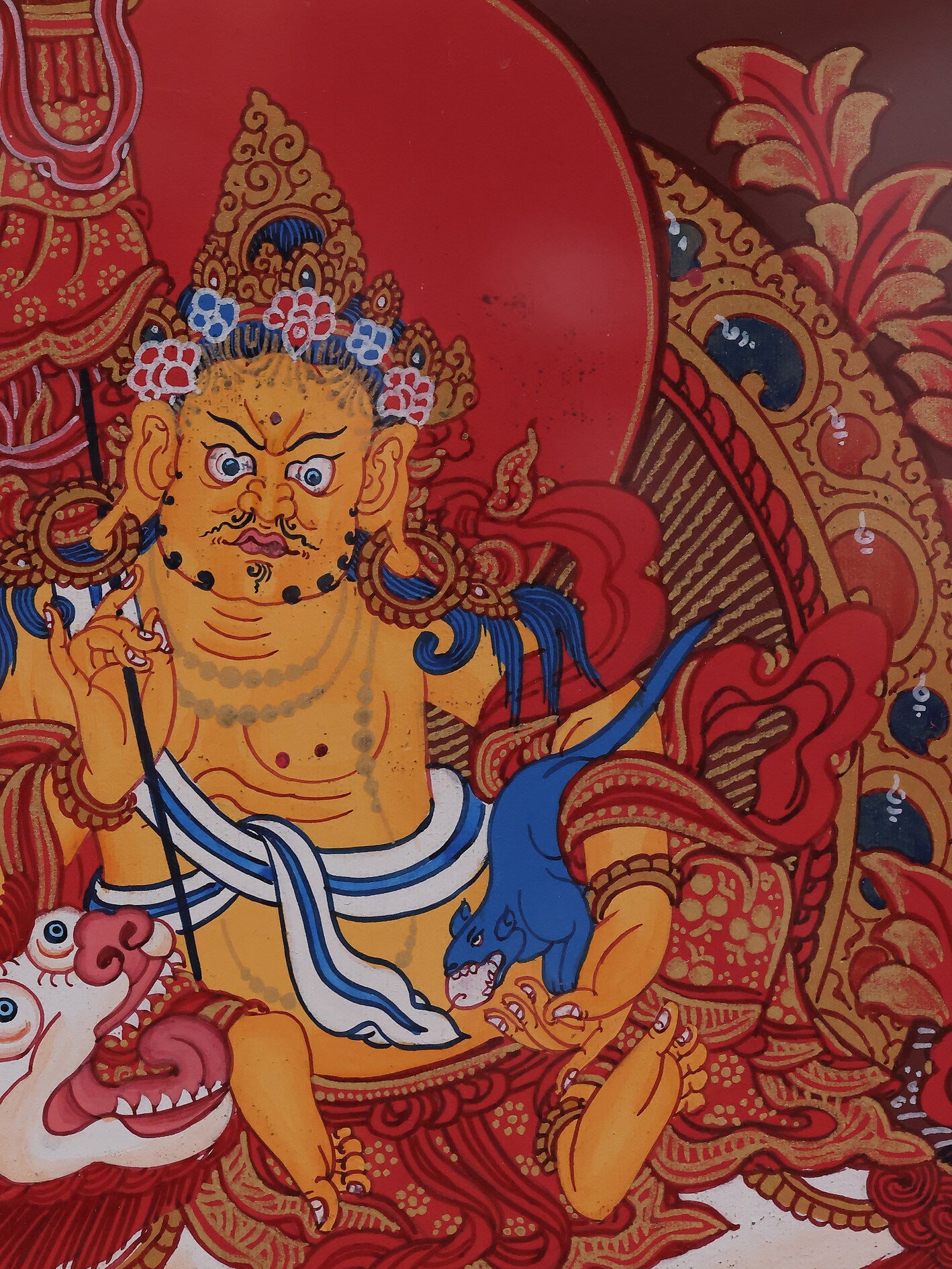 Alt: Luxurious Tibetan Thangka artwork in red, representing the Treasure King deity.