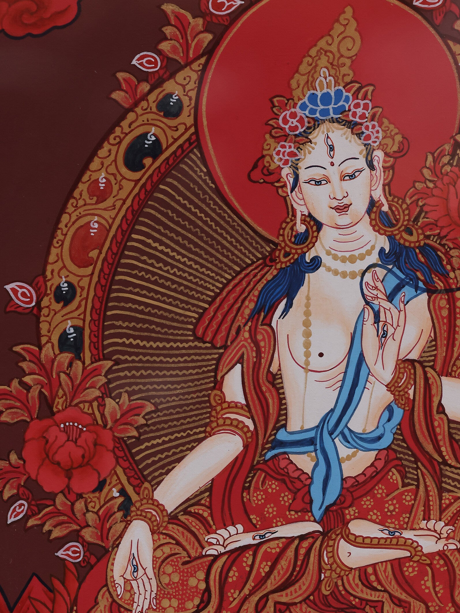 Tibetan Buddhist art showing White Tara on a red background thangka, embodying mercy and longevity