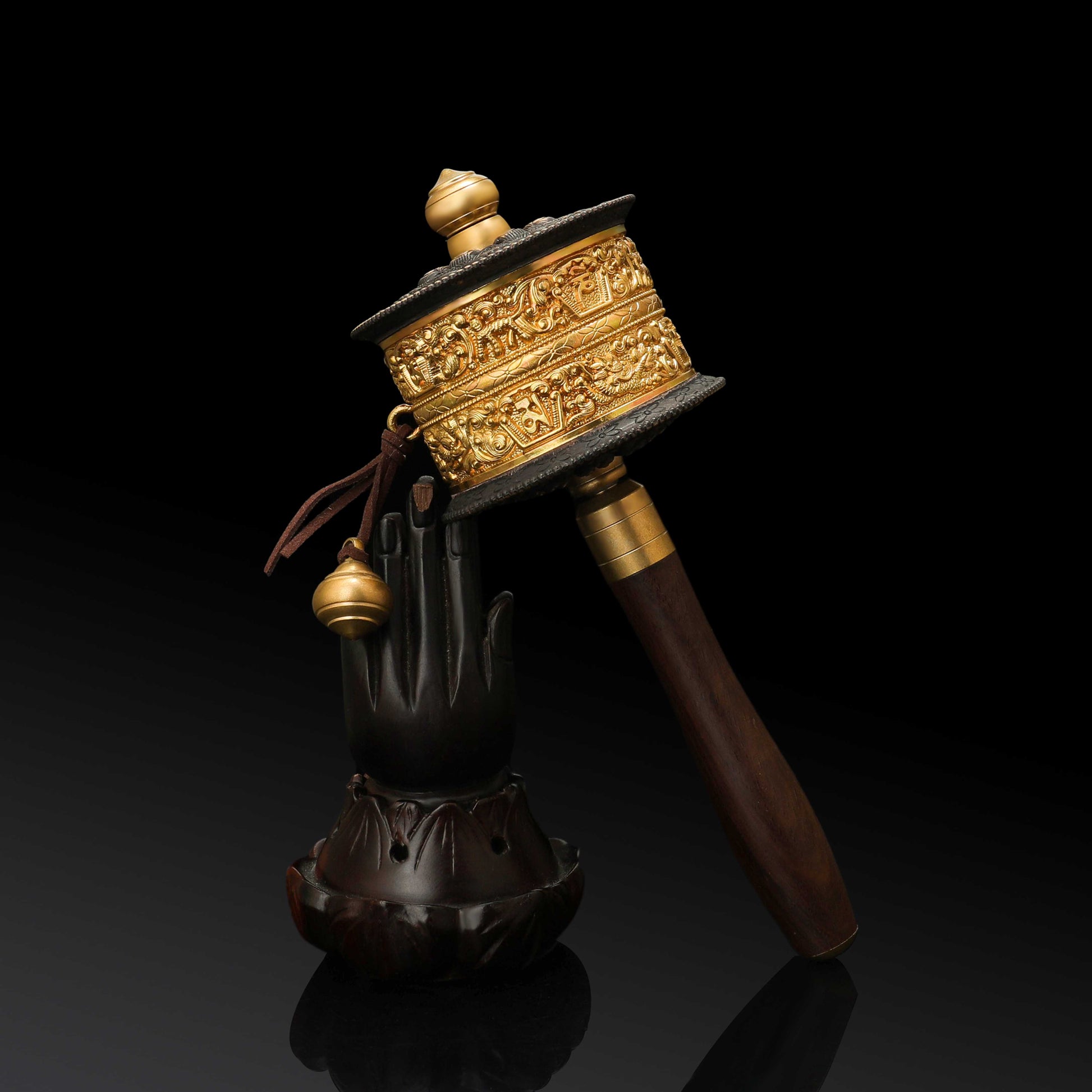 Close-up of a traditional Tibetan Buddhist Mani wheel showing intricate carvings and mantras