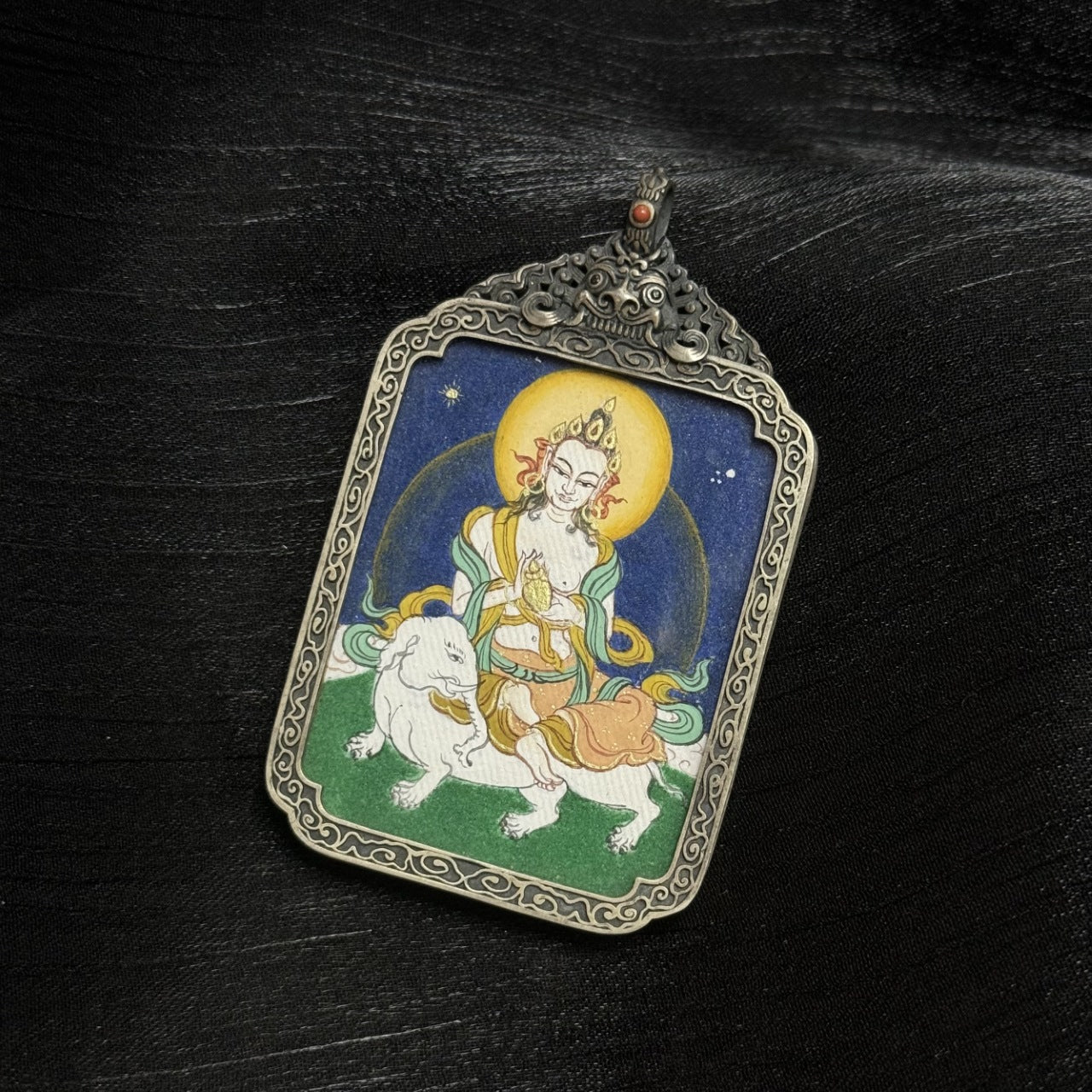  Close-up detail of the Bold Samantabhadra Thangka painting showing intricate natural mineral pigment work and symbolic attributes, showcasing the artistry of Tibetan lineage painters.
