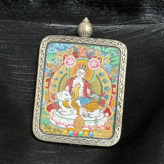 The Menri Samantabhadra Thangka pendant displayed as a sacred amulet for virtue and great conduct, embodying Universal Virtue in Tibetan Buddhist tradition.

