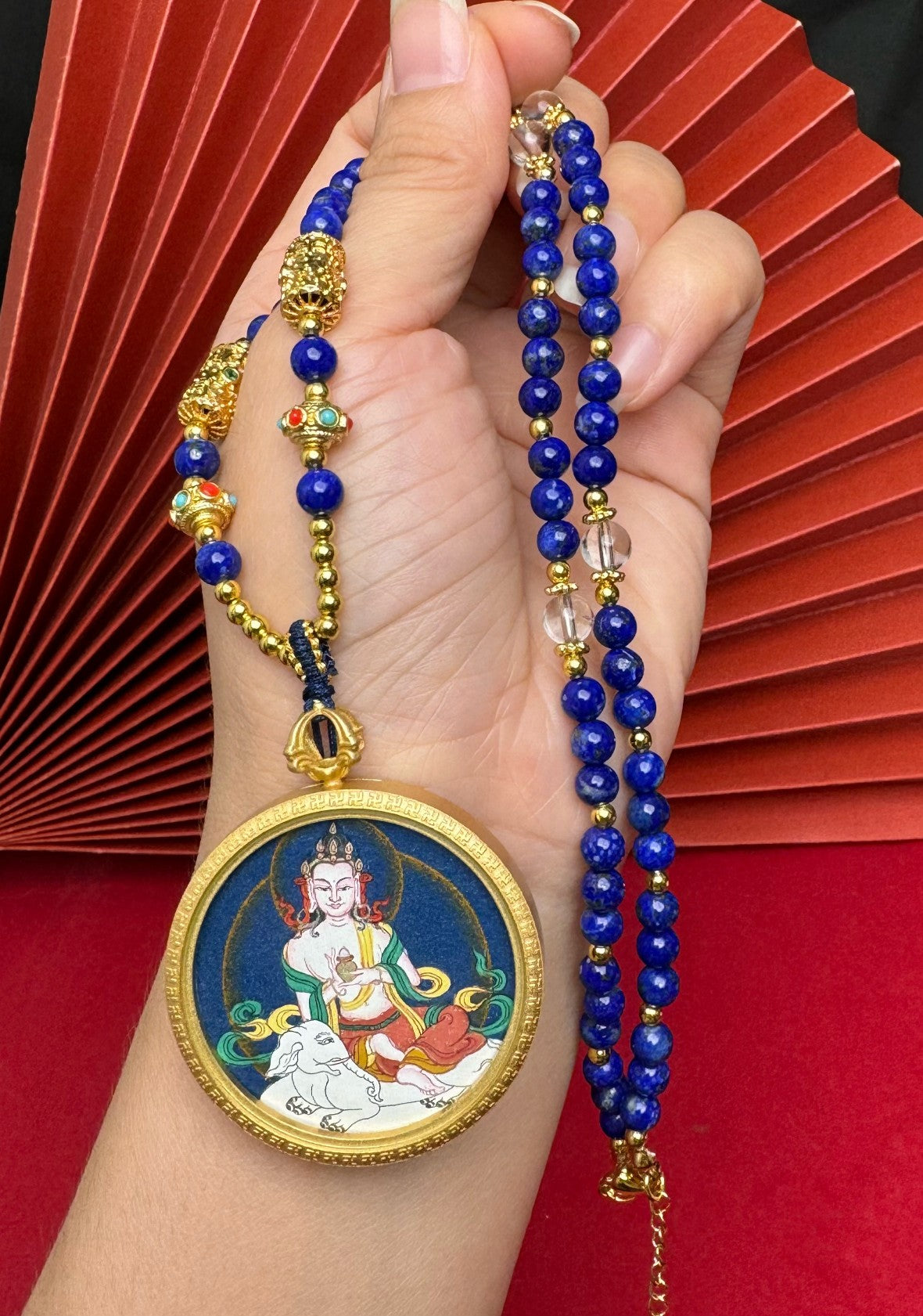  The Tibet Bold Samantabhadra Thangka pendant with copper casing displayed as a sacred amulet for virtue and the fulfilment of wishes, embodying Buddhist tradition.

