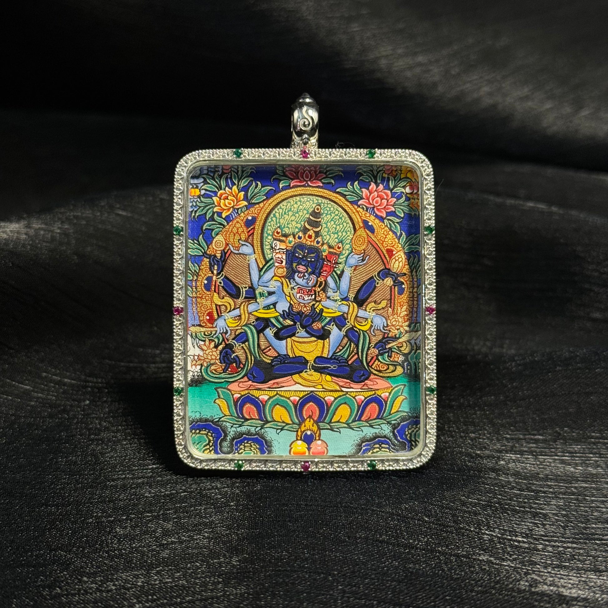  A 4x5cm hand-painted Rekong Samvara Thangka pendant with 925 silver casing, representing compassion, pacification and wisdom in Buddhist tradition.
