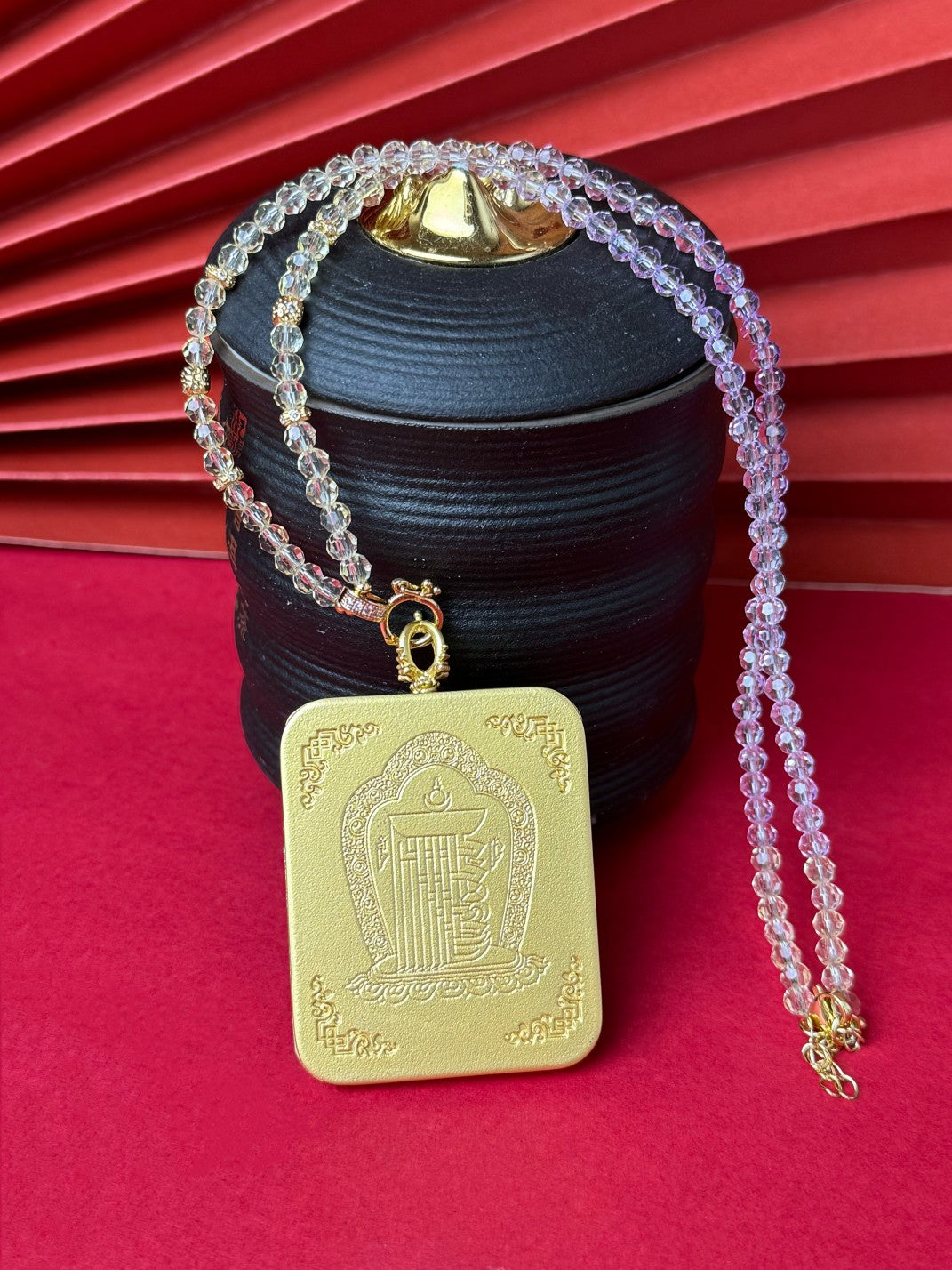  The Nepal Shachilama Past and Present Thangka pendant with copper casing displayed as a sacred amulet for perseverance and fortune, embodying Buddhist tradition.
