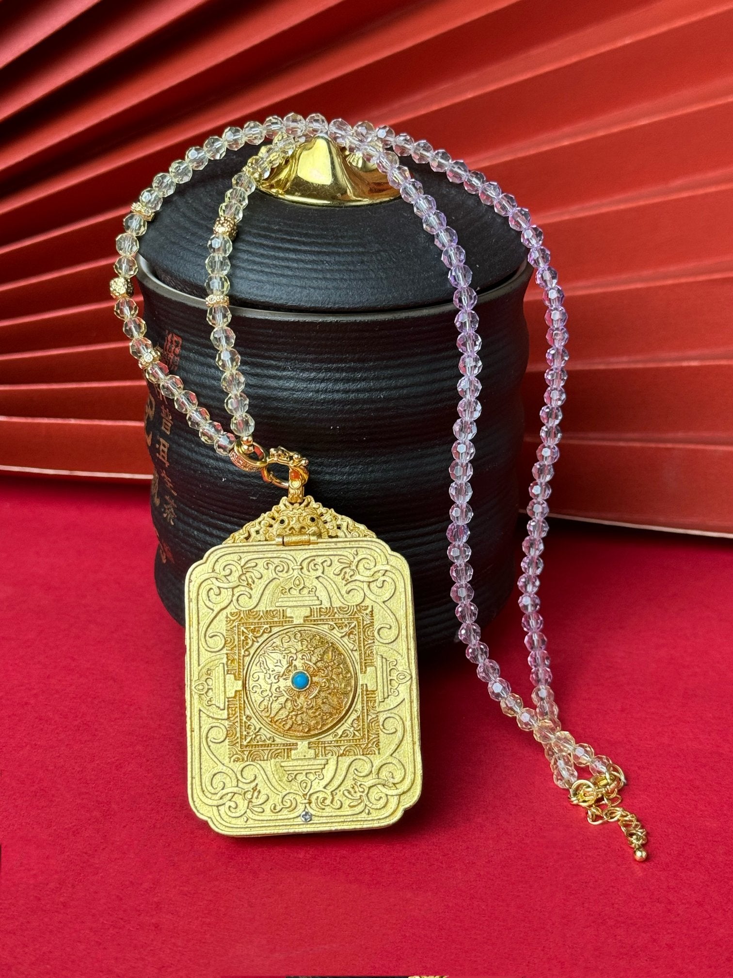  The Nepal Shachilama Past and Present Thangka pendant with copper casing displayed as a sacred amulet for perseverance and fortune, embodying Buddhist tradition.
