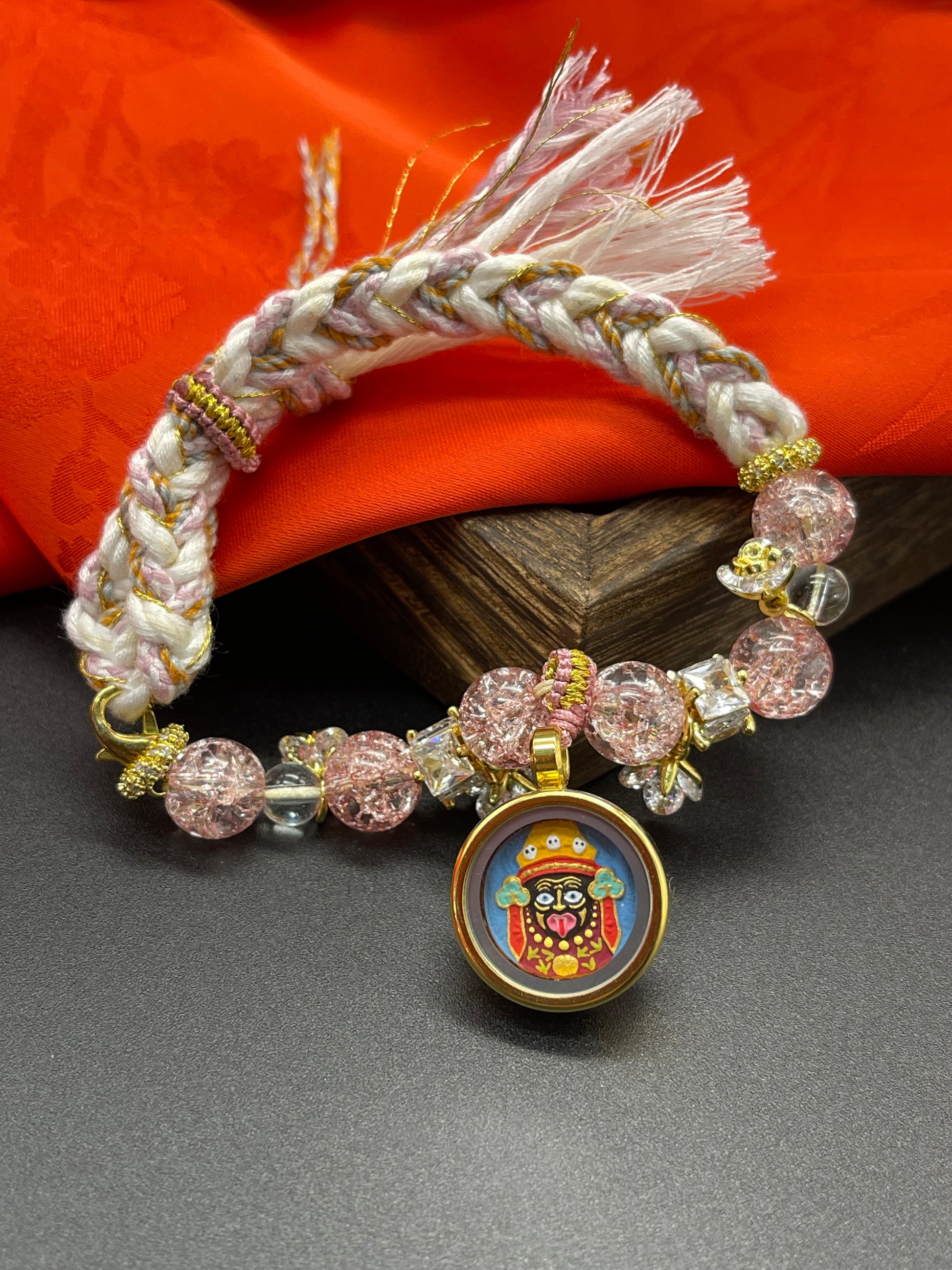 The Shachilama Painted Tsa-Tsa with rose quartz bracelet displayed as a sacred amulet for swift wealth and the fulfilment of wishes, embodying Buddhist tradition.
