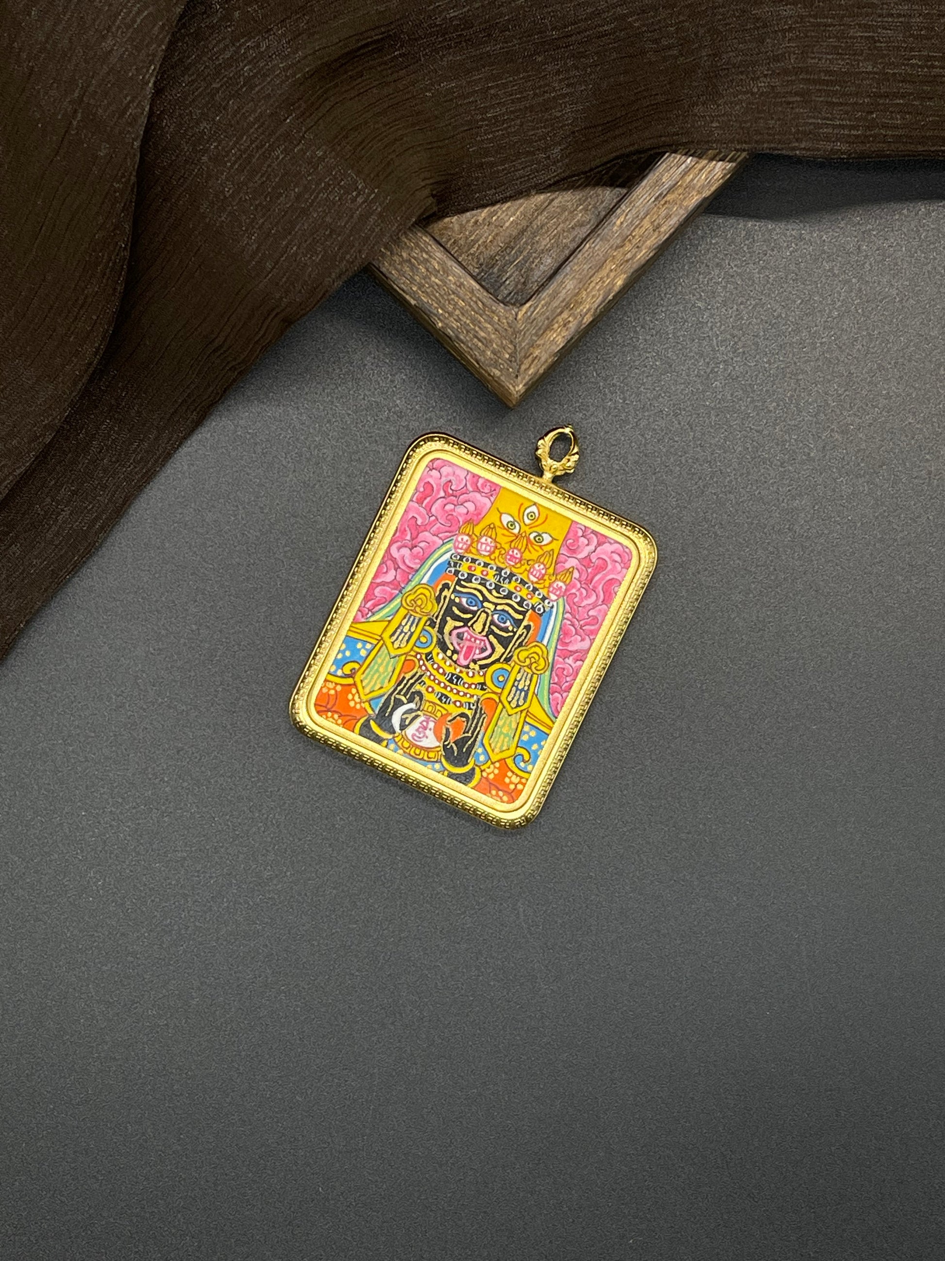 The Nepal Shachilama Pink Thangka pendant with titanium casing displayed as a sacred amulet for wealth and peace, embodying Buddhist tradition.
