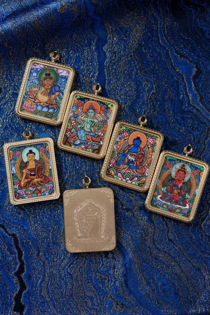Shakyamuni Buddha thangka pendant representing enlightenment and awakening in traditional Tibetan Buddhist art.