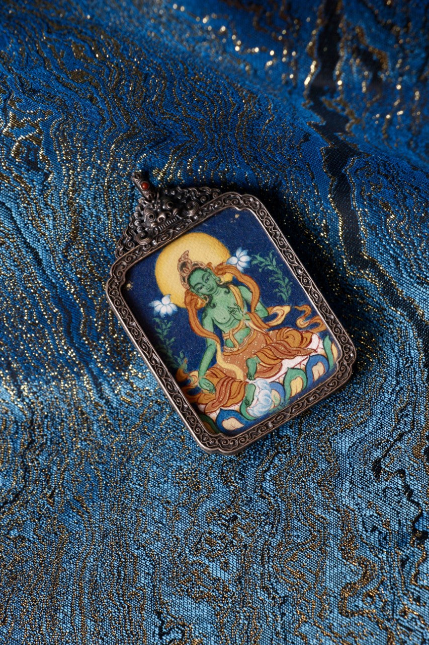 Tibetan thangka jewelry featuring Green Tara, inspired by traditional Tibetan Buddhist sacred art.