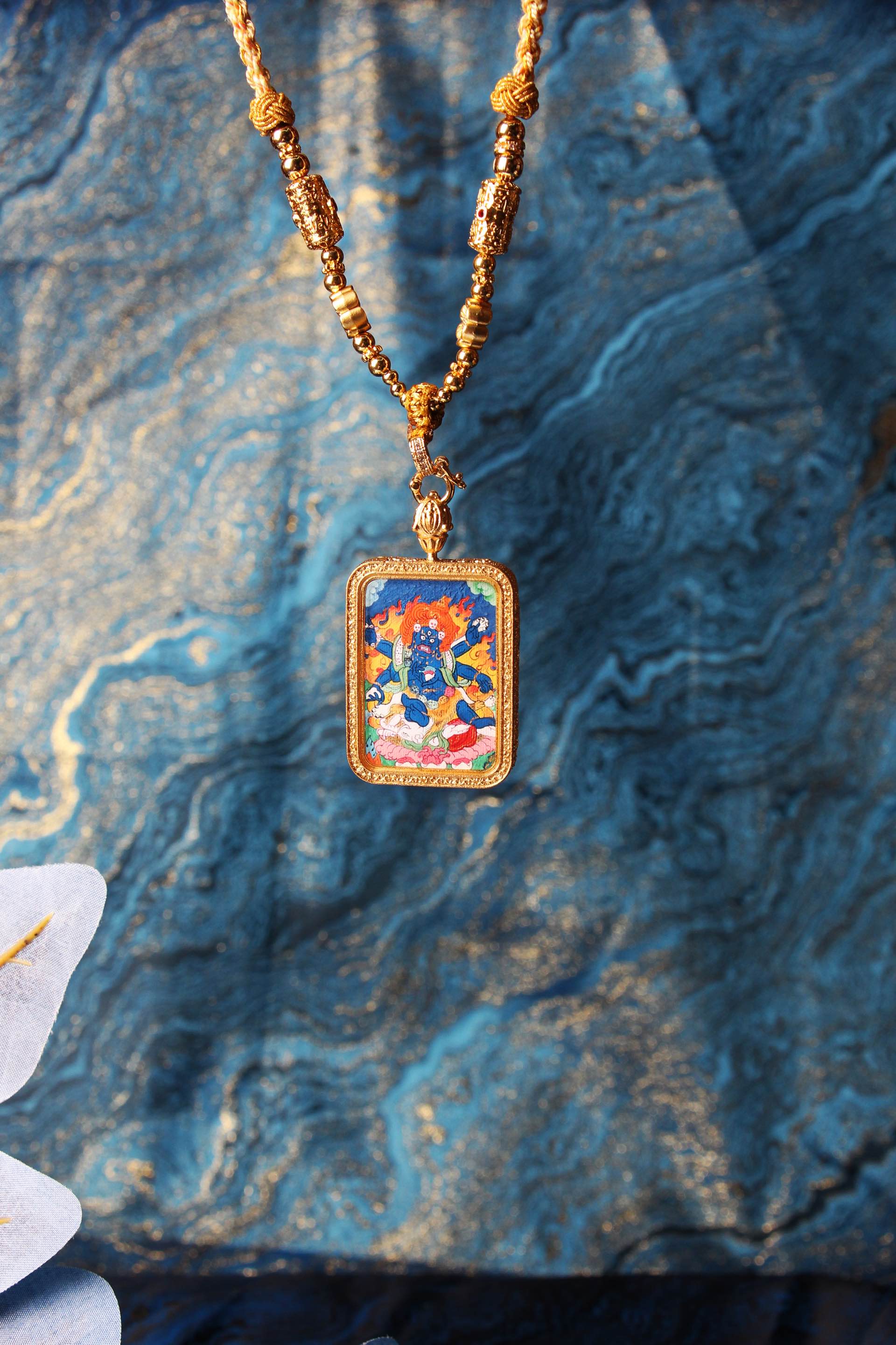 The Tibetan Buddhist Six-Armed Mahakala Dharmapala Thangka pendant displayed as a sacred protective amulet, embodying the fierce blessing and obstacle-removing power of Tibetan Buddhist tradition.
