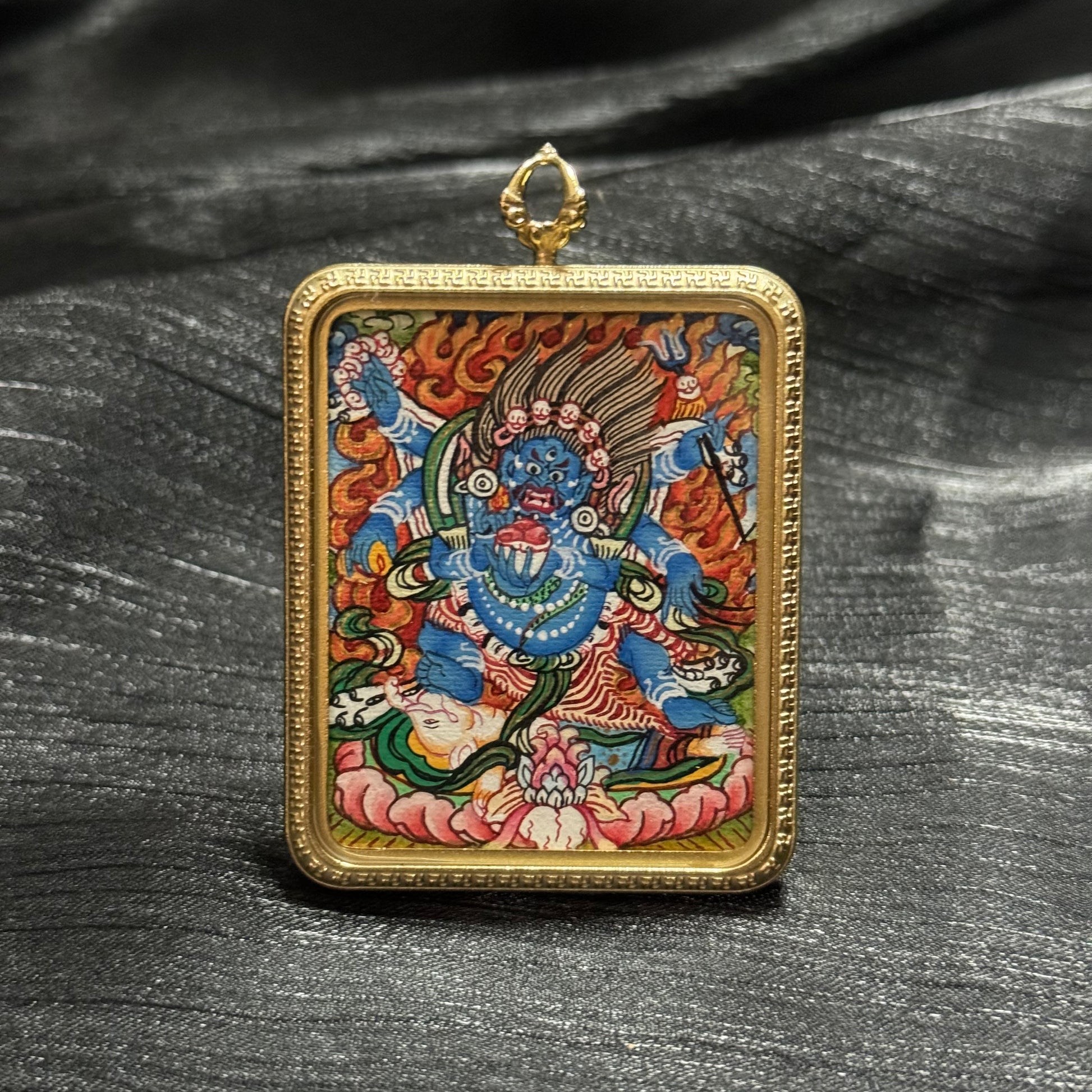 The Nepal Six-Armed Mahakala Thangka pendant displayed as a sacred amulet for protection and wealth, embodying Buddhist tradition.
