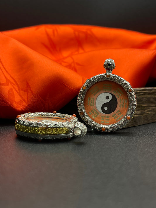 A 3.5x4.5cm hand-painted Rekong Taiji Bagua (太极八卦) pendant featuring the cosmic cycle and Eight Trigrams, representing balance and feng shui in Chinese tradition.
