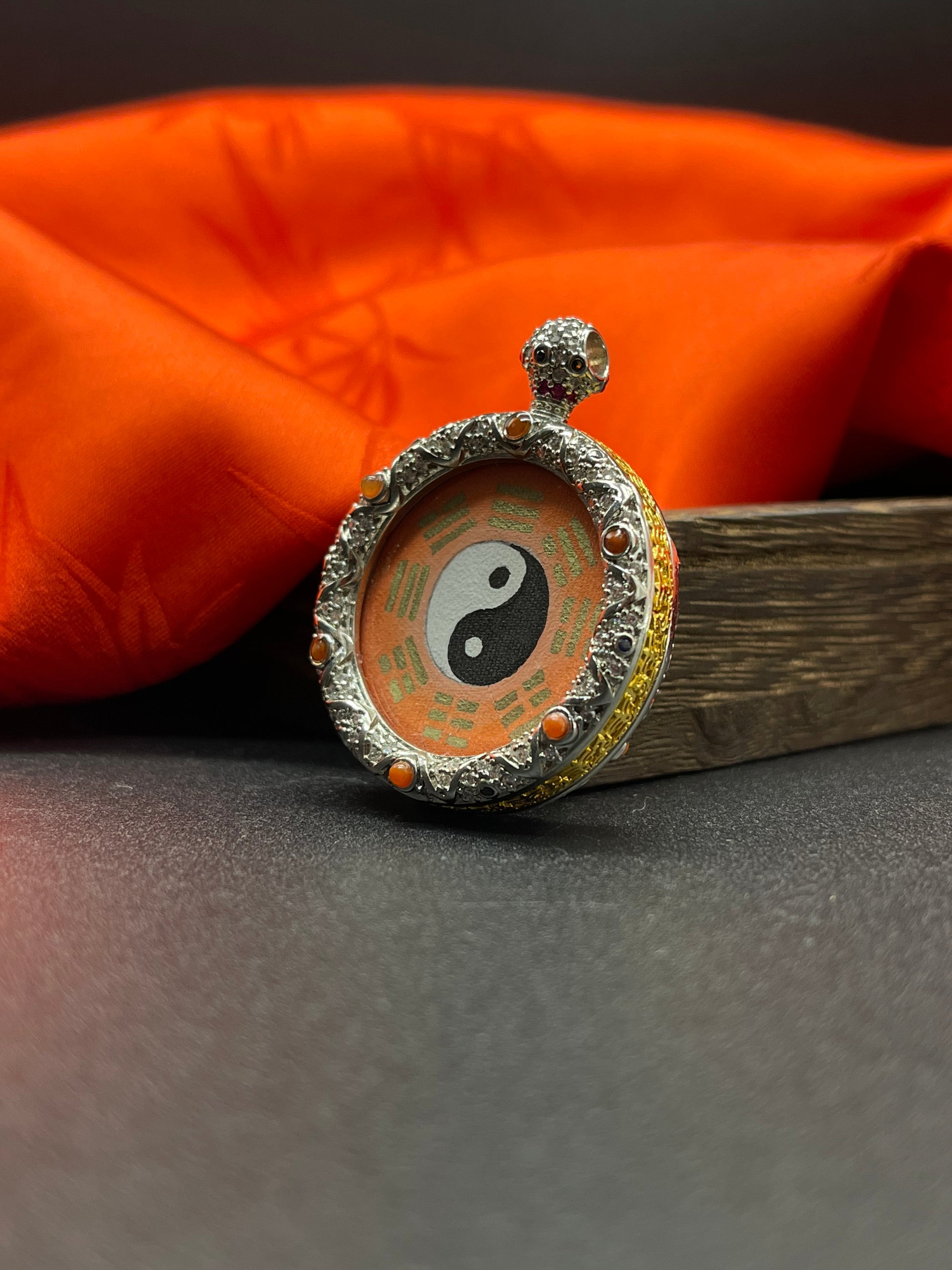 The Rekong Taiji Bagua pendant displayed as a sacred amulet for balance and feng shui, embodying Chinese tradition.
