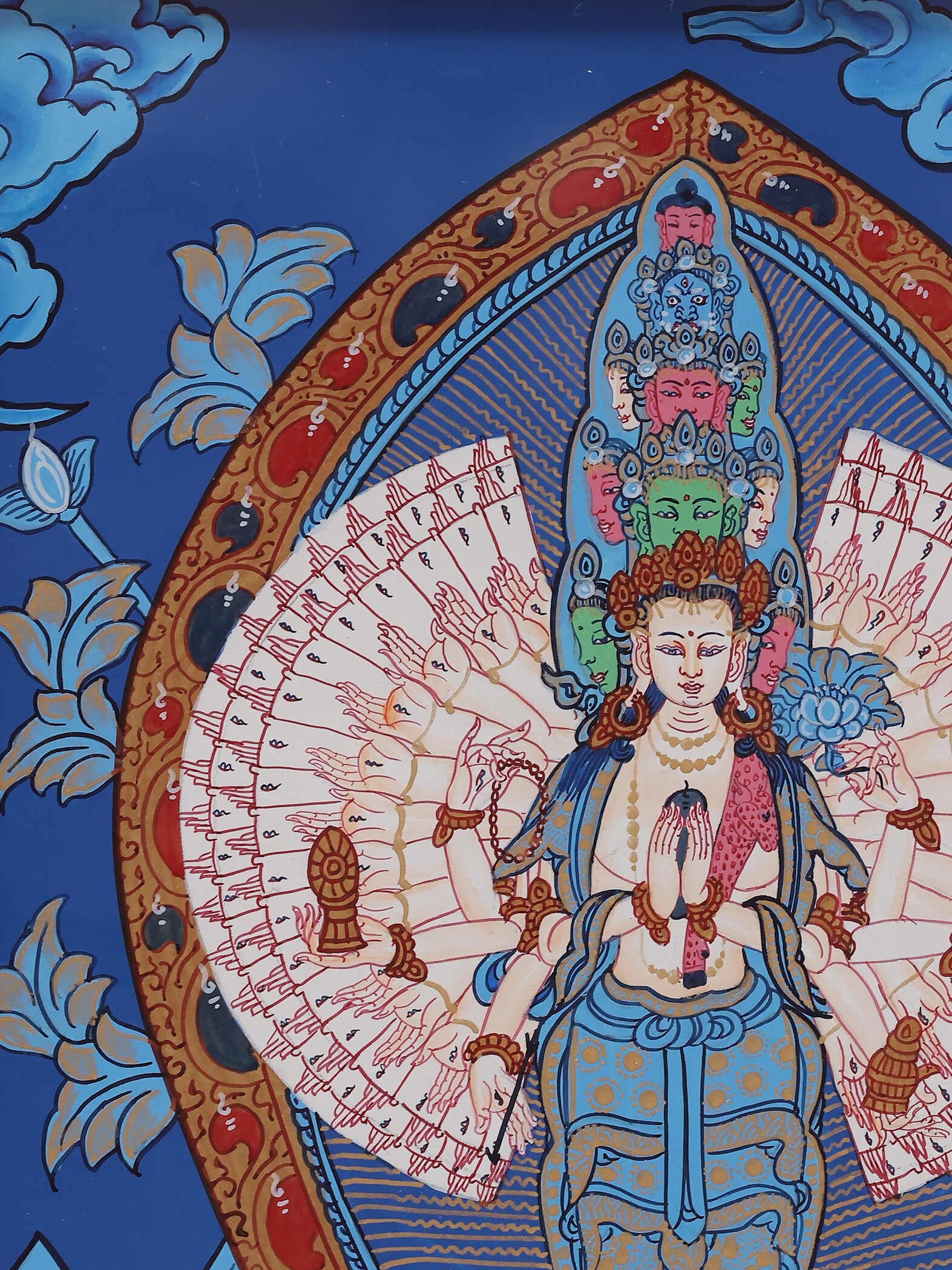 Sacred hand-painted Avalokiteshvara Thangka, featuring eleven faces, multiple hands holding ritual implements, and vibrant mineral pigments.