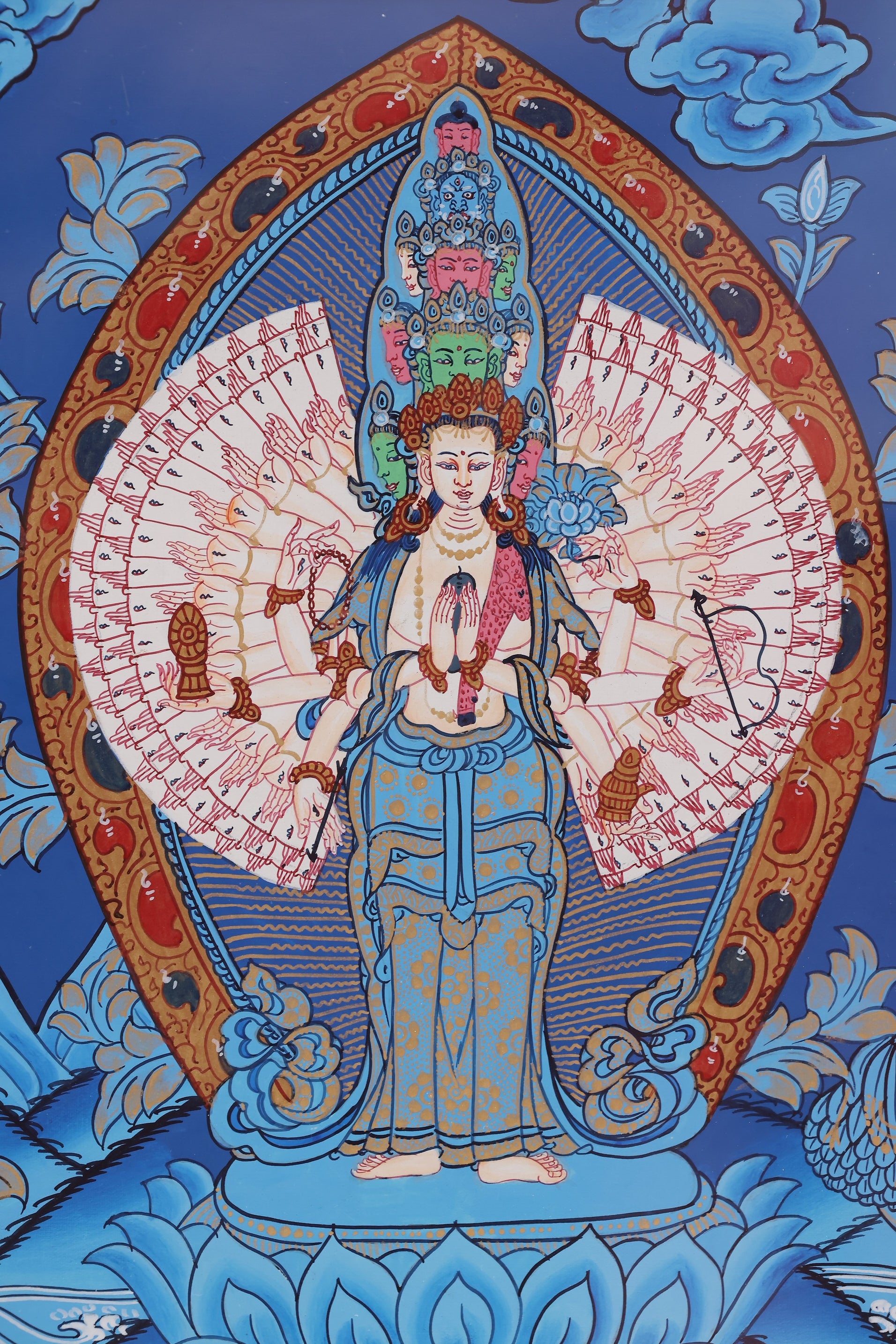 Eleven-Faced Thousand-Hand Thousand-Eyed Avalokiteshvara Thangka, highlighting sacred iconography and vibrant gold detailing.