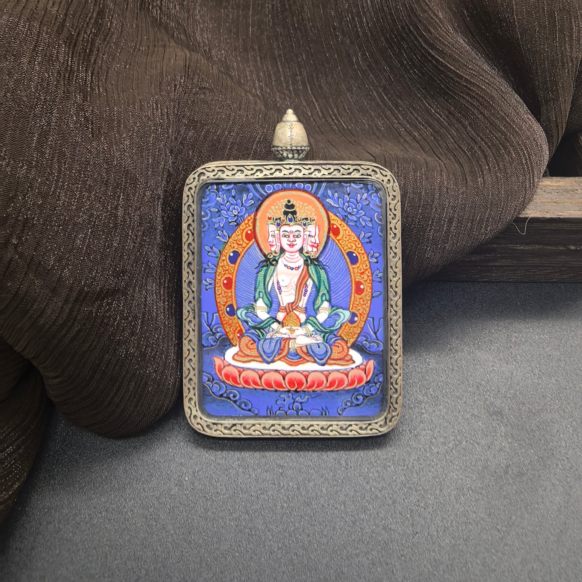  Close-up detail of the Rekong Blue Thangka Vairocana painting showing natural mineral pigments, showcasing the masterful artistry of Rekong lama painters.

