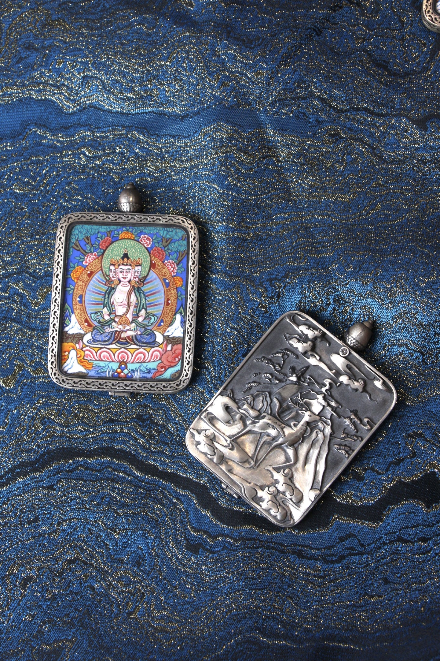 Close-up of the S925 sterling silver case with Dunhuang Nine-Colored Deer engraving, protecting the Vairocana Thangka.