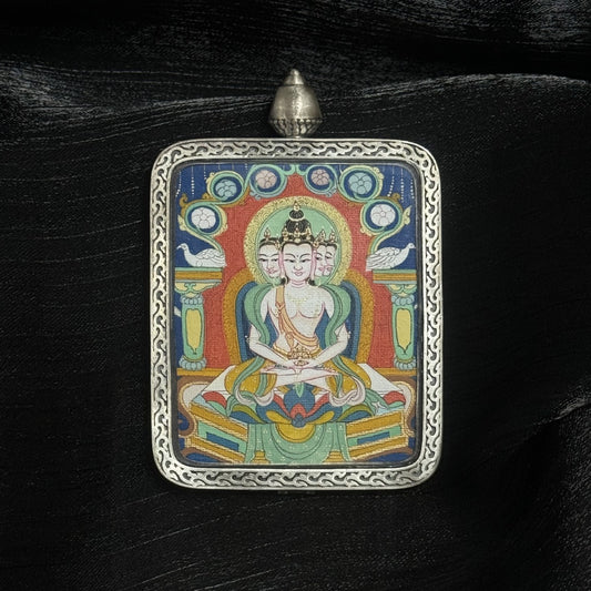 The Chigung Vairochana Thangka pendant displayed as a sacred amulet for wisdom and success, embodying the cosmic light of Tibetan Buddhist tradition.
