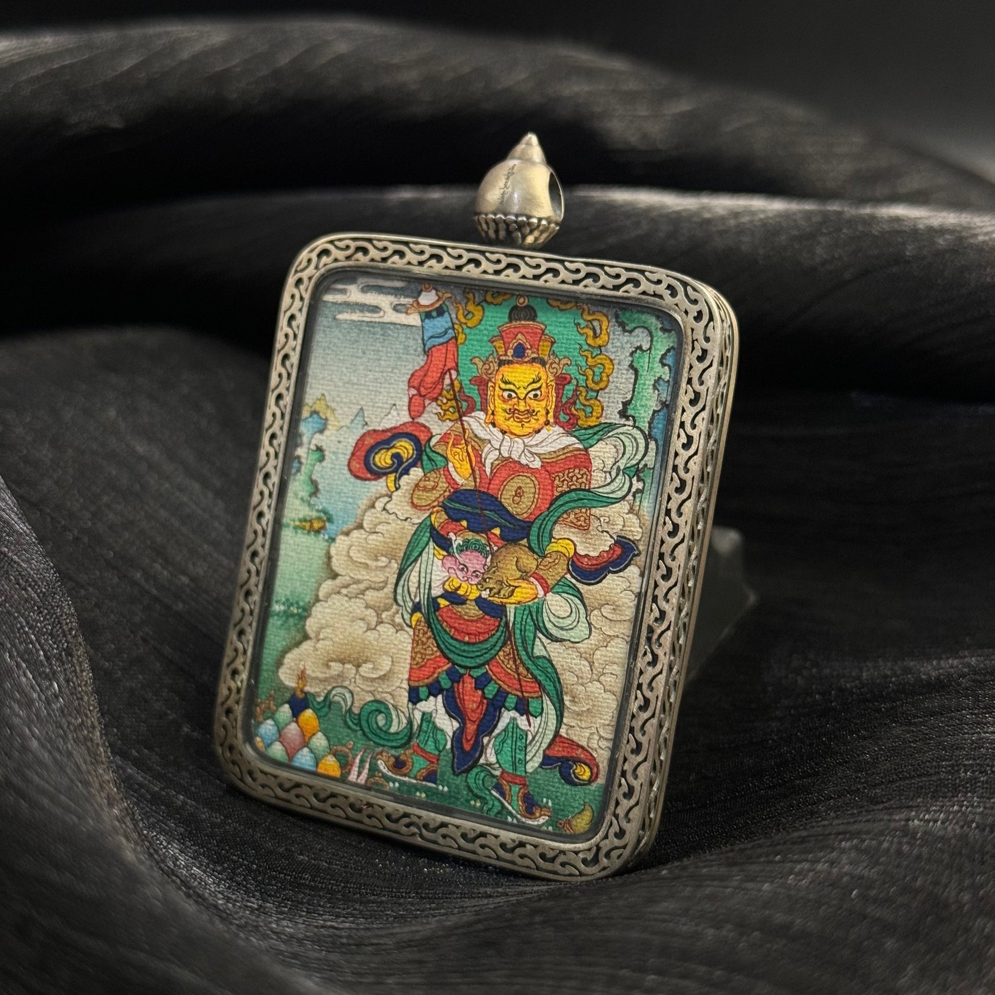  Detailed view of the presentation and casing for the Vaishravana Cuiying Thangka pendant.
