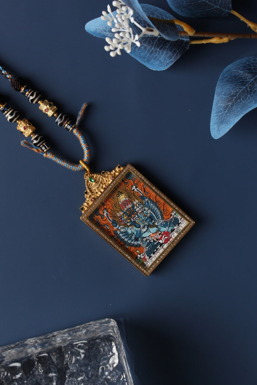  A 4x5cm hand-painted Nepal Vajrabhairava (Yamantaka) Thangka pendant featuring the Conqueror of Death, encased in titanium steel, representing fierce wisdom and obstacle removal in Tibetan Buddhist tradition.
