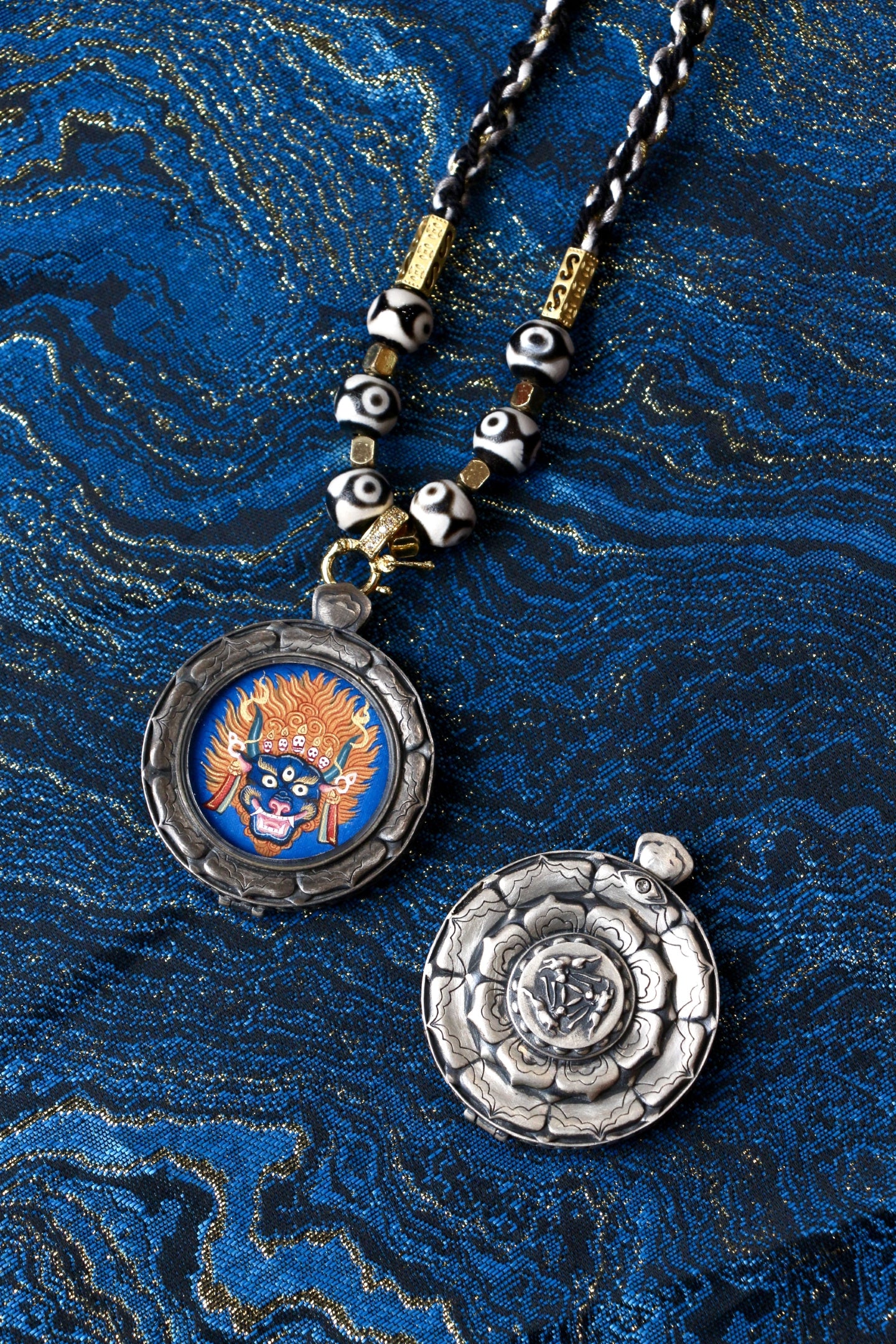 The Tibetan Buddhist Vajrabhairava Buddha Head Thangka pendant displayed as a sacred protective amulet for spiritual practice and daily wear, embodying the fierce wisdom and compassionate protection of Tibetan Buddhist tradition.
