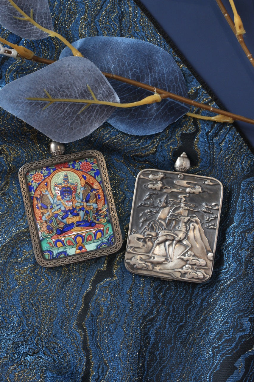 Tibetan Buddhist thangka pendant depicting Vajradhara, the Multitude Vajra deity, symbolizing supreme spiritual power and enlightenment.