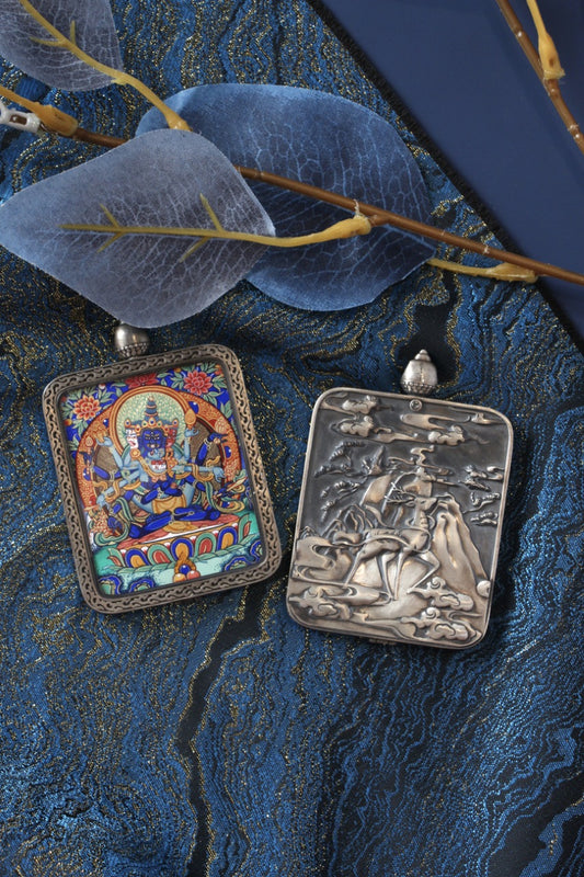 Tibetan Buddhist thangka pendant depicting Vajradhara, the Multitude Vajra deity, symbolizing supreme spiritual power and enlightenment.