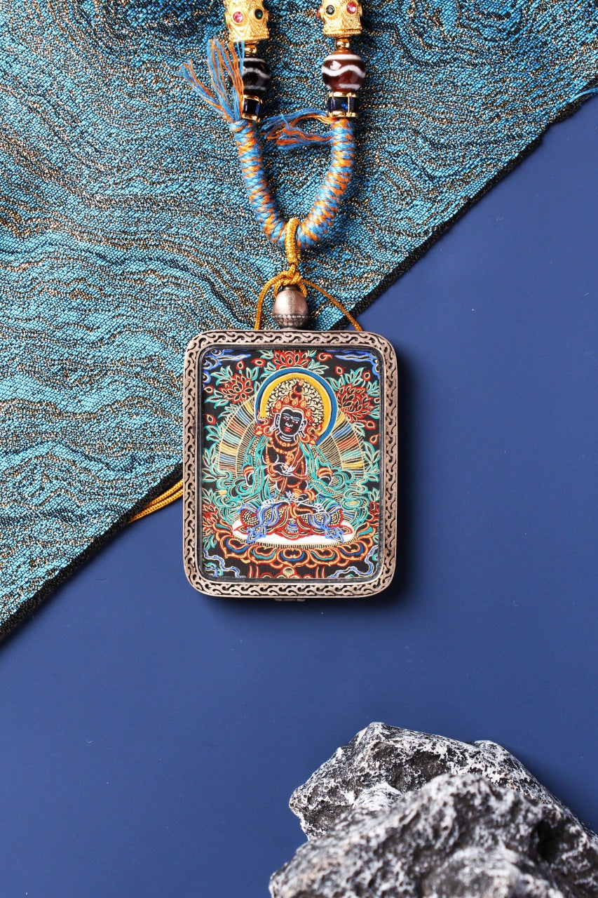 Detailed view of the exclusive 925 Sterling Silver casing for the Vajrasattva Thangka pendant, symbolizing protection and elegance in Tibetan Buddhist tradition.

