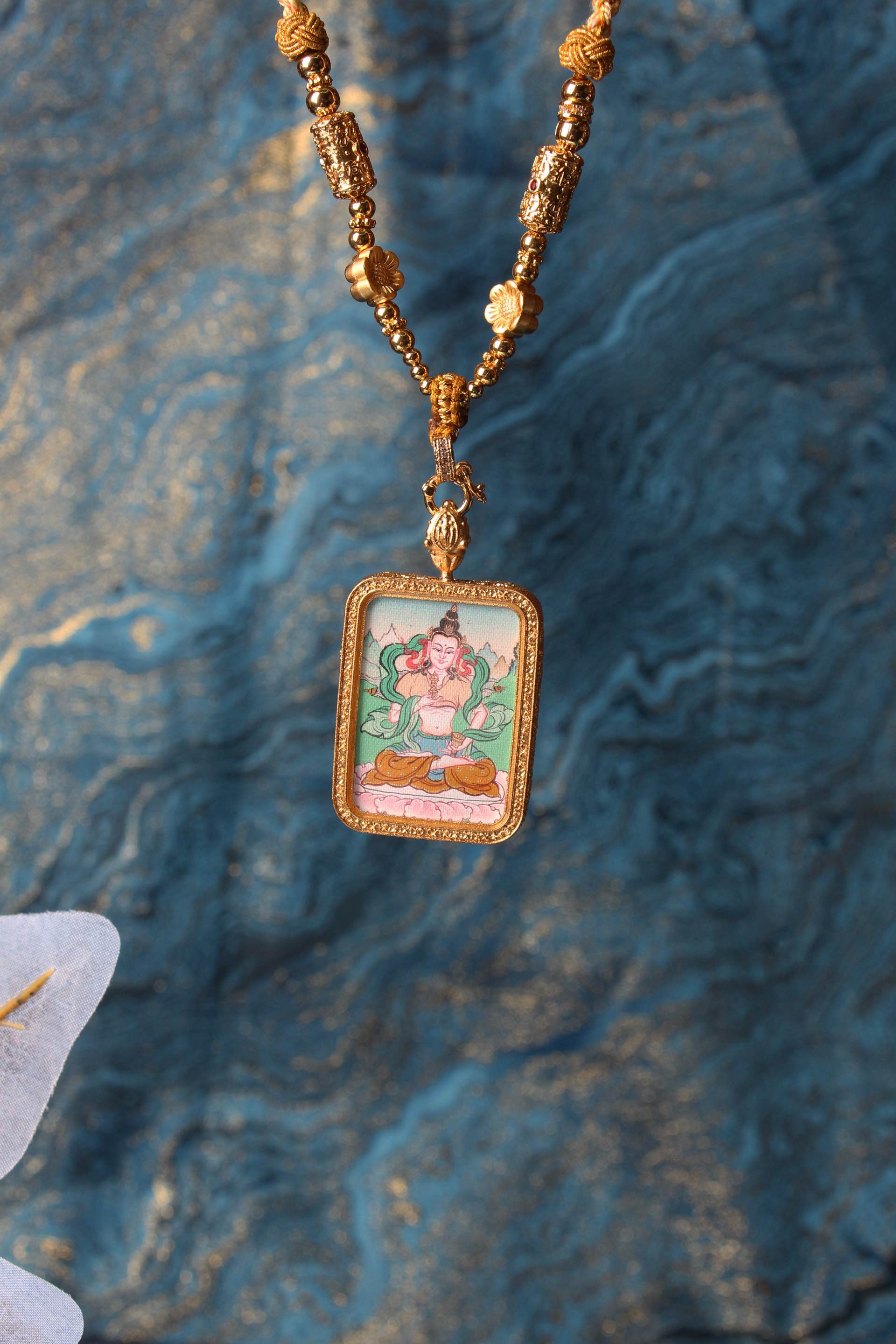 The Tibetan Buddhist Vajrasattva Thangka pendant displayed as a sacred amulet for karma purification and spiritual renewal, embodying the purifying power of Tibetan Buddhist tradition.
