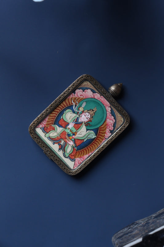 Tibetan Buddhist thangka pendant depicting White Tara, symbolizing long life, compassion, and healing blessings.