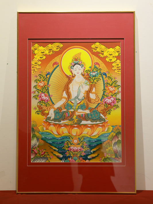 Colorful Tibetan Thangka of White Tara, showcasing intricate lotus throne and symbolic hand gestures for compassion and longevity.
