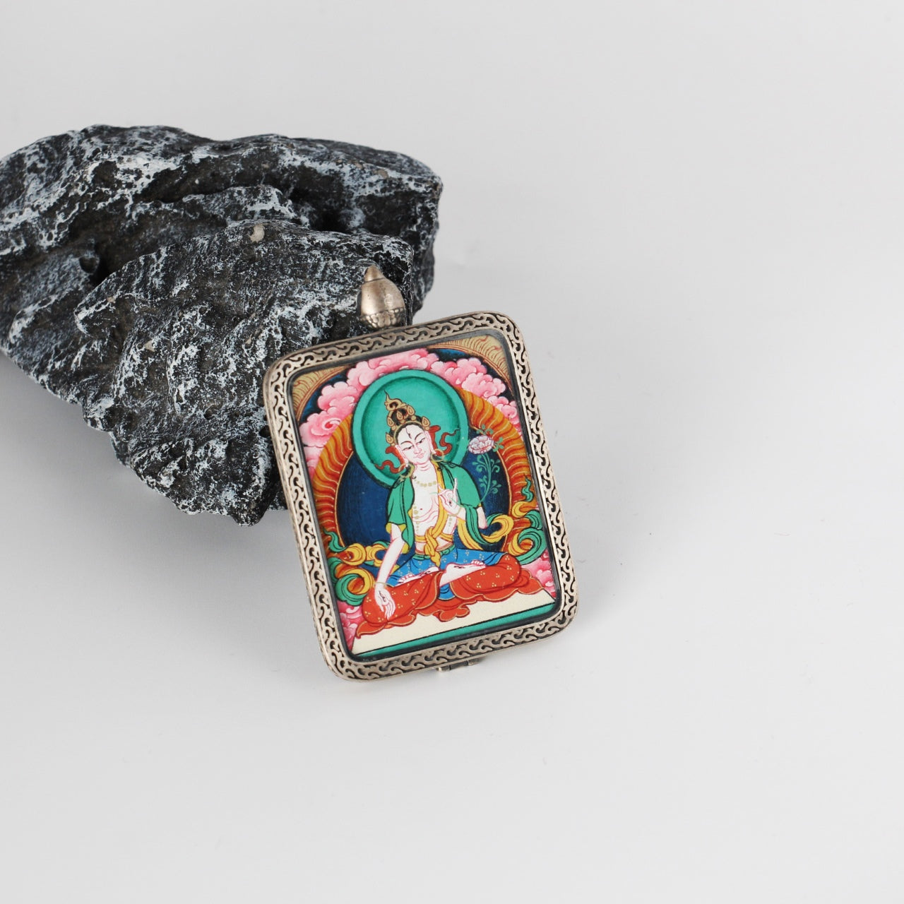 The Rebgong White Tara Thangka pendant displayed as a sacred amulet for longevity and liberation, embodying Tibetan Buddhist tradition.

