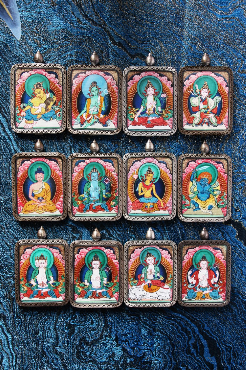 Tibetan thangka amulet featuring White Tara, revered in Tibetan Buddhism for healing, protection, and longevity.