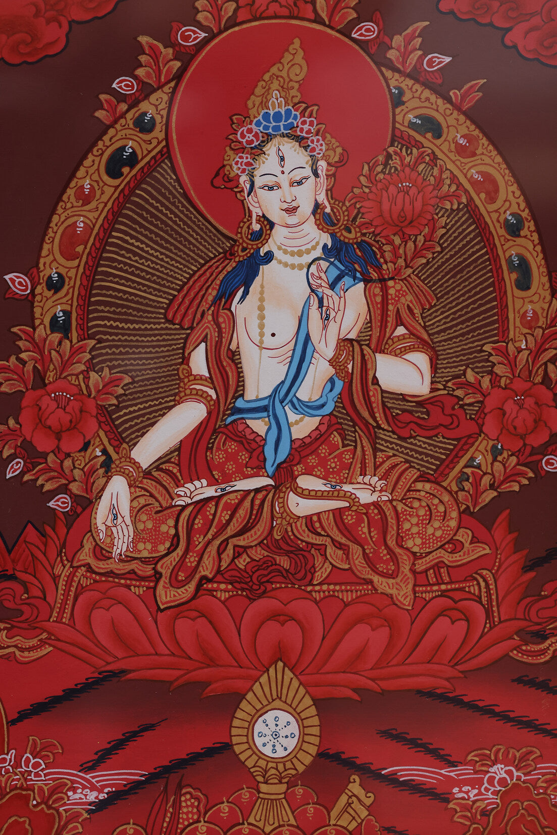 Red thangka painting of White Tara, symbolizing longevity, healing, and compassionate blessings in Tibetan Buddhist art