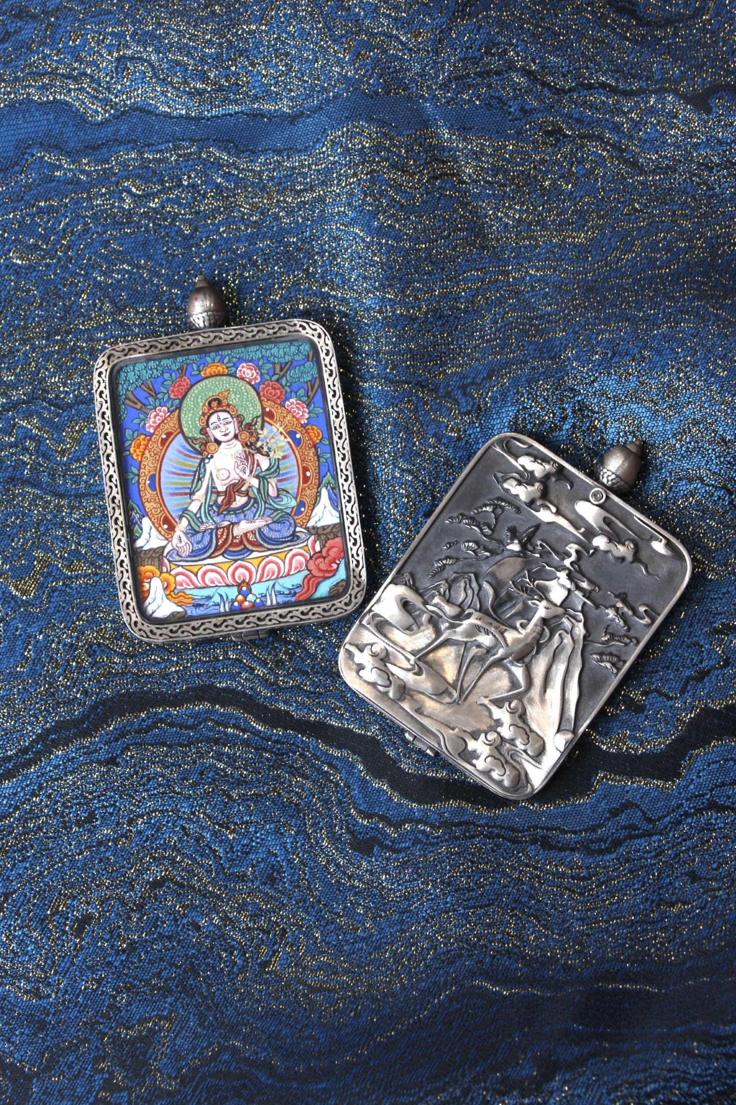 Close-up of the S925 sterling silver case with Dunhuang Nine-Colored Deer engraving, protecting the White Tara Thangka.