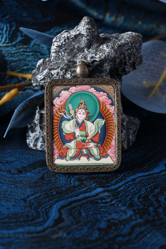 Thangka necklace portraying White Tara, the bodhisattva of compassion associated with longevity and wisdom.