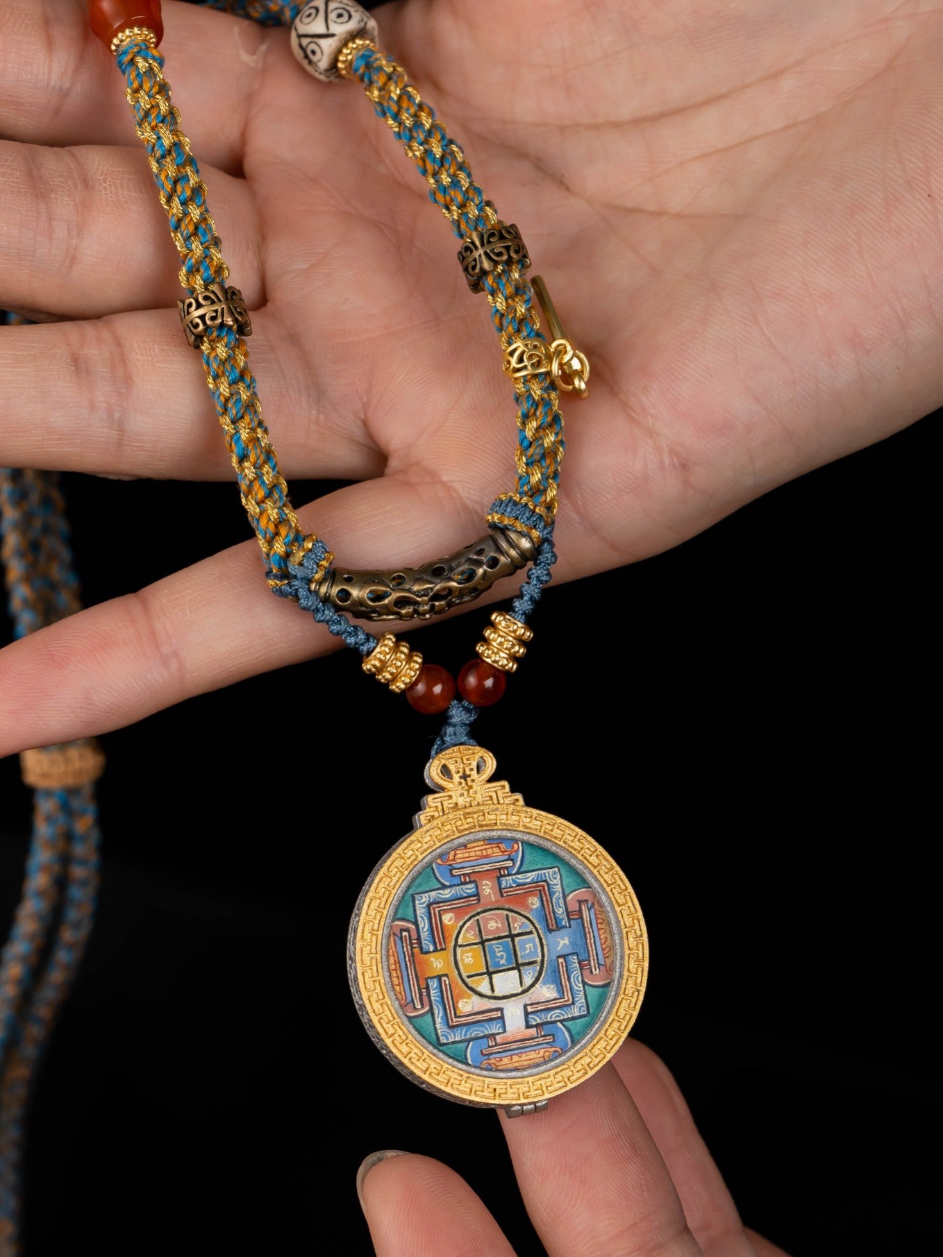 Close-up detail of the Rekong Yamantaka Mandala Thangka showing hand-painted mineral pigments, showcasing the masterful artistry.

