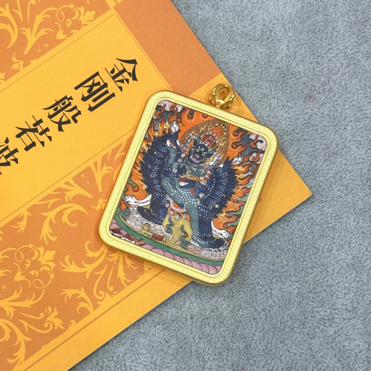 Detailed view of the copper alloy casing for the Yamantaka Thangka pendant, symbolizing protection and tradition in Tibetan Buddhist art.